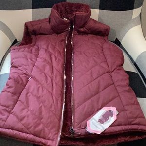 Maroon vest with fuzzy inside, adult small brand new with tags